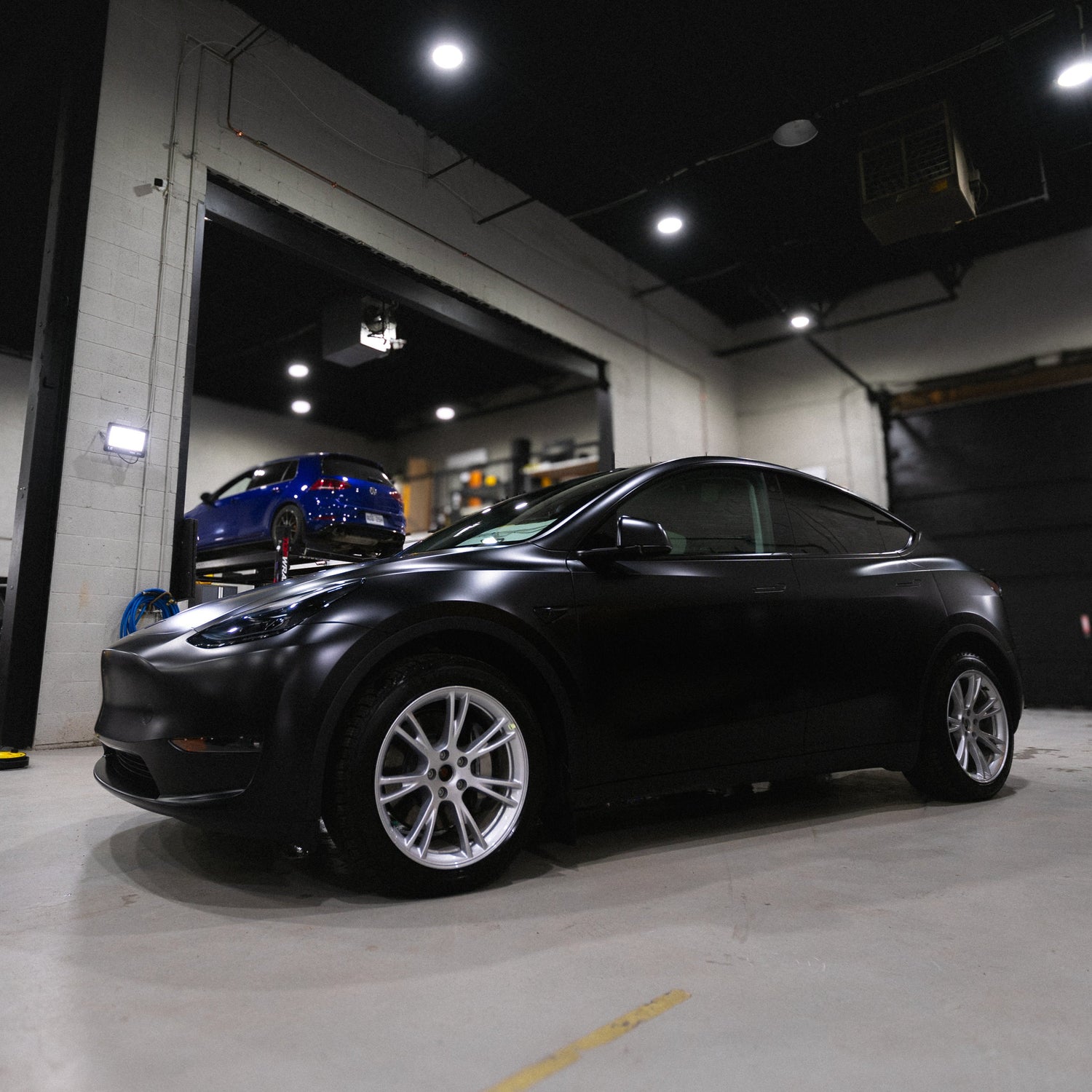 Tesla Model Y black inside a garage